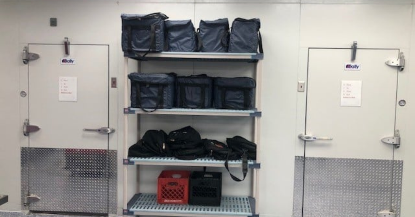 About: two walk-in refrigiration entries with rack of coolers inbetween