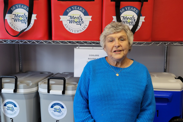 Betsy standing by meal route coolers