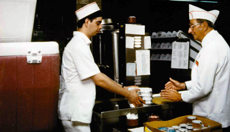 50th Anniversary: two men packing meals