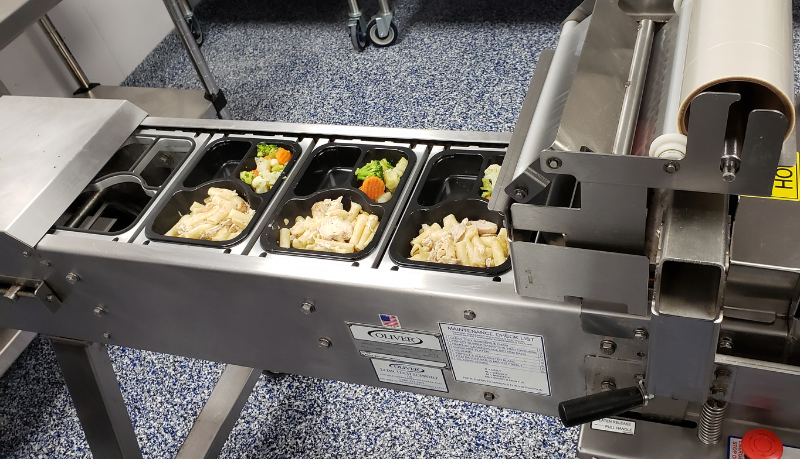 50th Anniversary look: Commercial kitchen meal tray sealer equipment