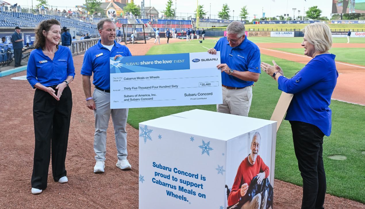 Subaru Team presenting oversized donation check  to Kimberly Strong, executive Director of Cabarrus Meals on Wheels