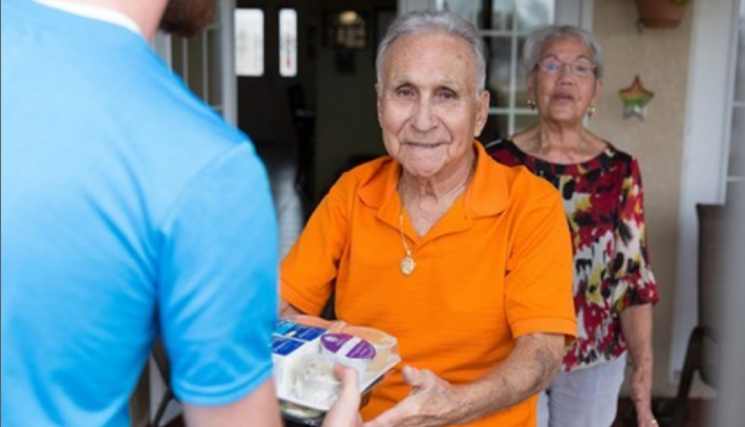 About Us: Client receving a meal delivery