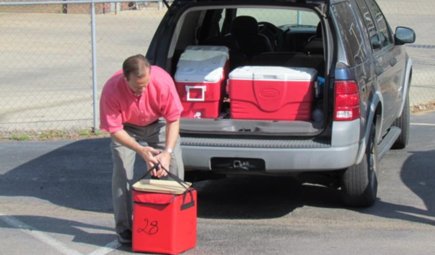 Delivery Guidelines page: man putting red coolers in back of vehicle