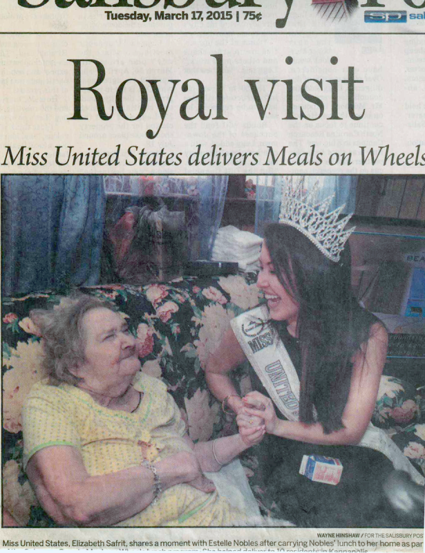 50th Anniversary look back: Newspaper clipping of Miss Universe sitting with a client as she delivers a meal